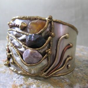 Mixed-metal 925 silvercuff bracelet with multiple tumbled stone accents.